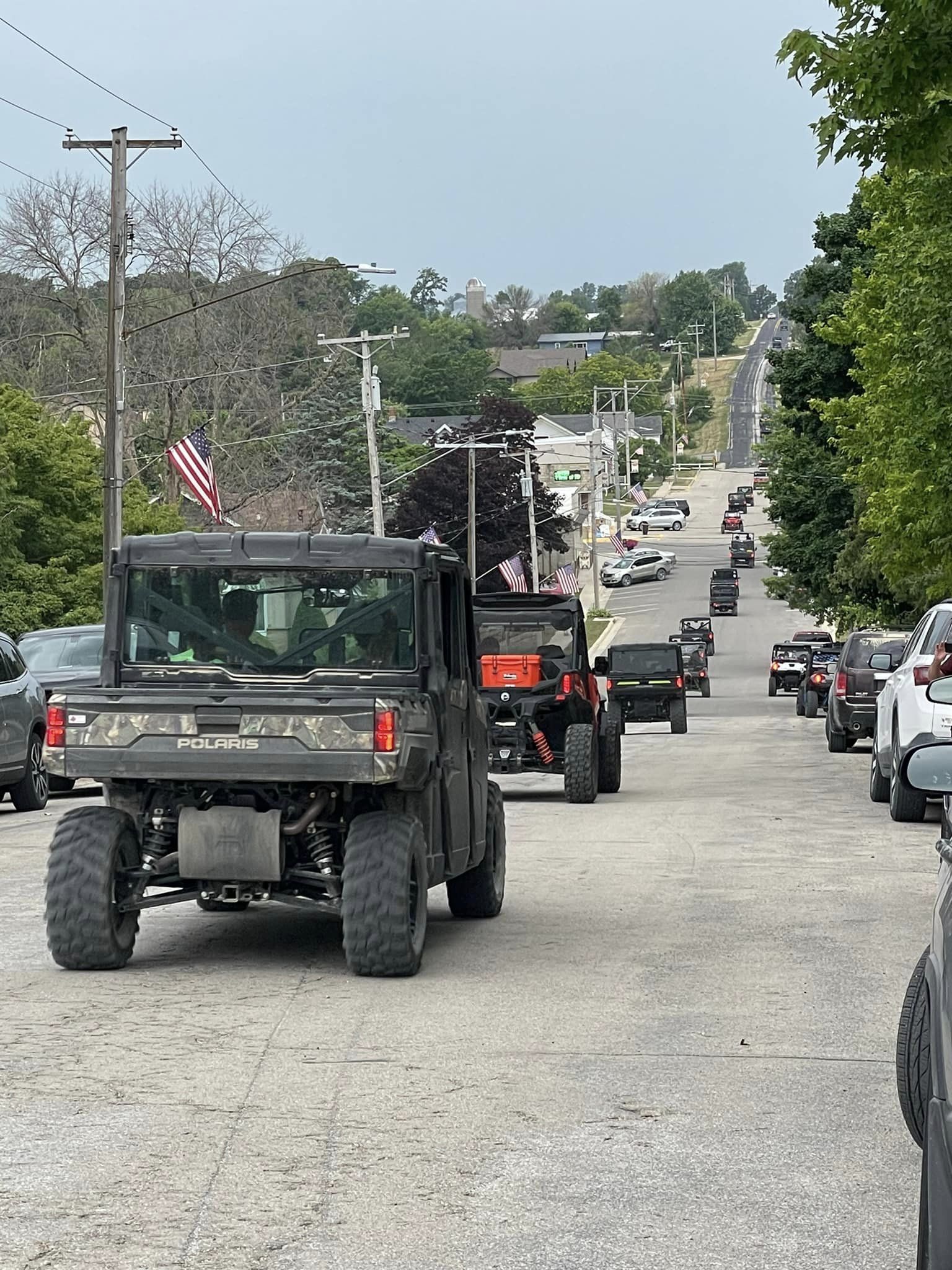 ATVs in a line going down the street